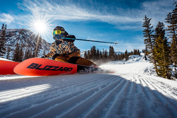 Skier leans over on edges