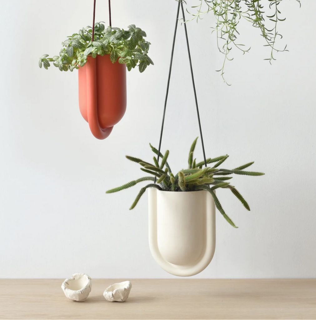 portico planter ceramic hanging planter in white and pink with plants