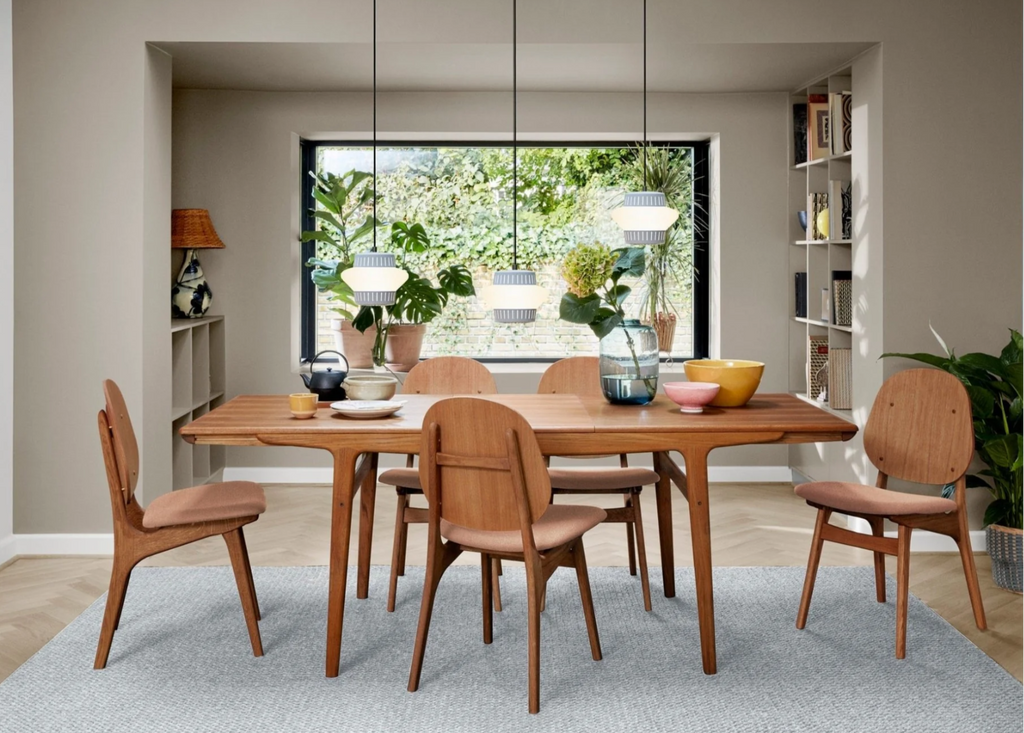 noble dining chairs arranged around dining room table with pendant lights and decor