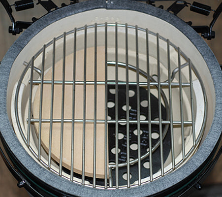 10 inch half-moon deflector sitting under the MiniMax cooking grid inside the MiniMax Big Green EGG.