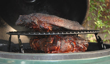 XL Big Green EGG Expander with XL Adjustable Rig barbequing two pork butts below a brisket packer inside an XL Big Green EGG.