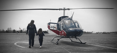 Jeriann walking to helicopter with daughter