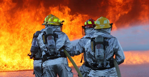 Anchorage Airport Police & Fire Dept. firefighters hosing off fire