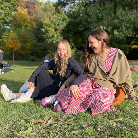 chaya and simi sitting on the grass in prospect park