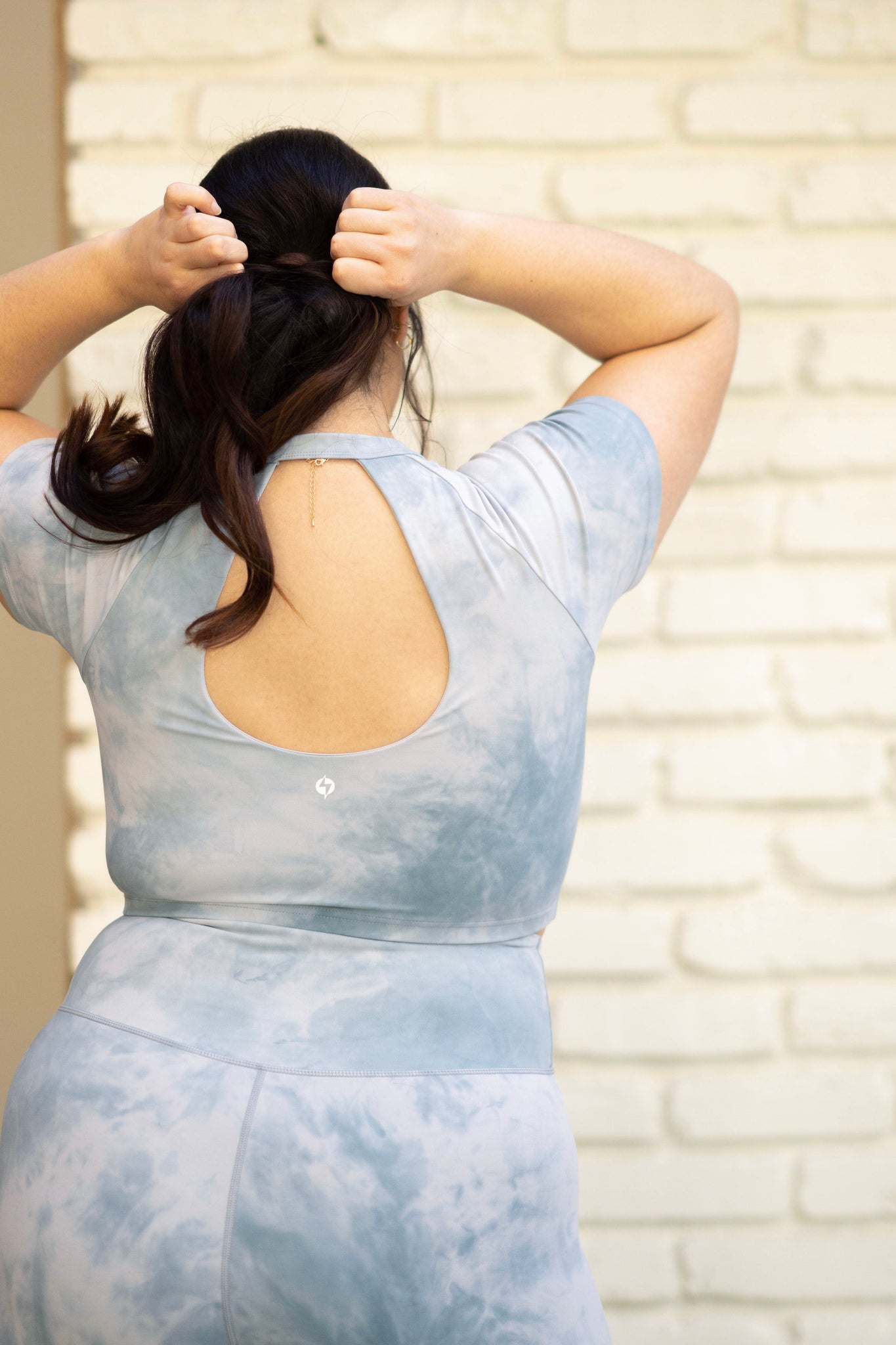 Back view of POPFLEX bliss baby tee marble collection cute activewear crop top