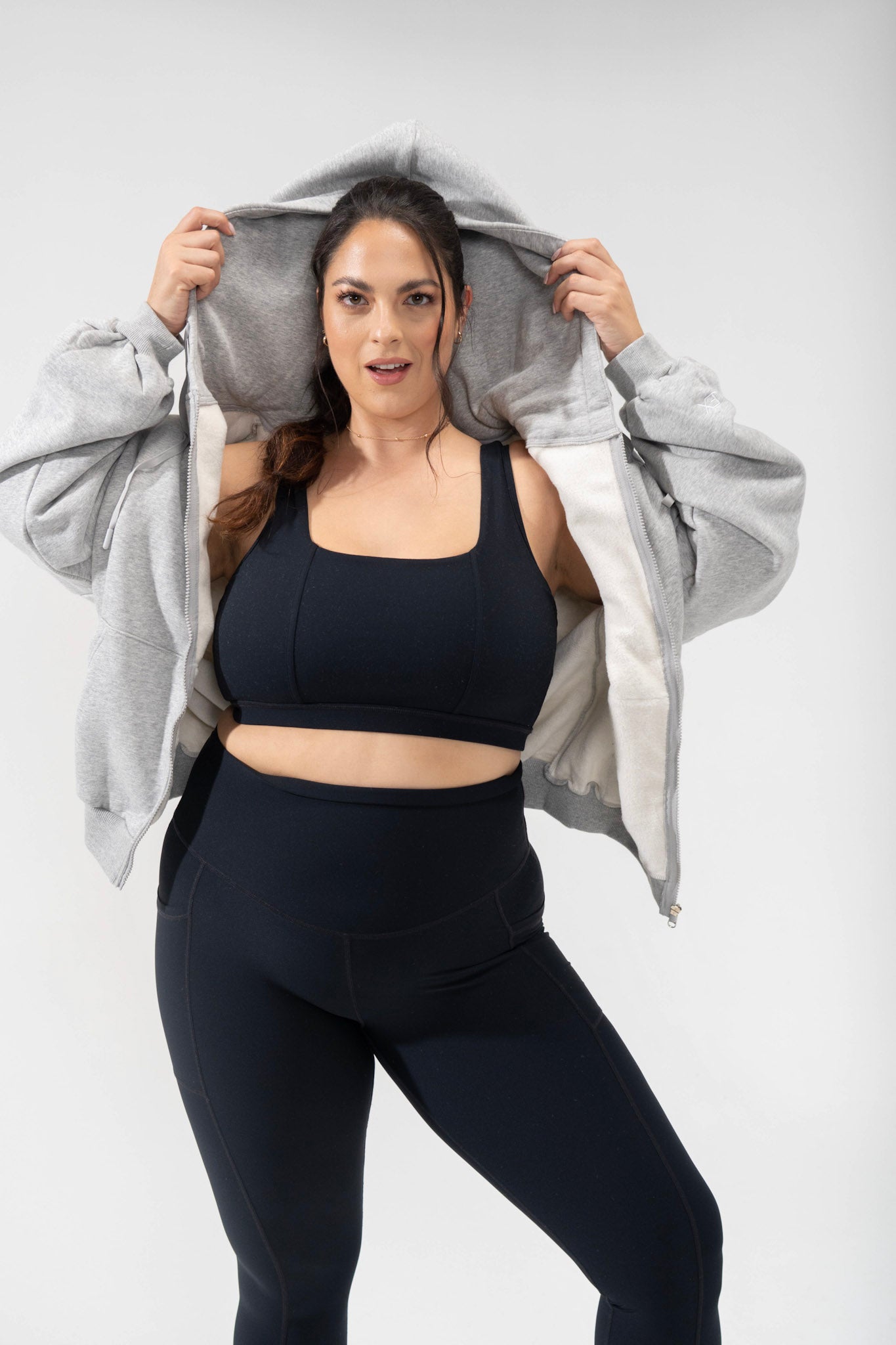 model shows the oversized hood of the cloud hoodie, a baggy hoodie from POPFLEX and the latest cute activewear basics line