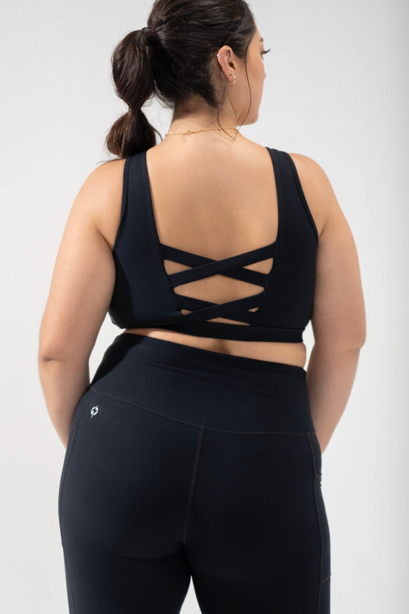 plus size corset bra cute activewear, model wears the POPFLEX criss cross sports bra