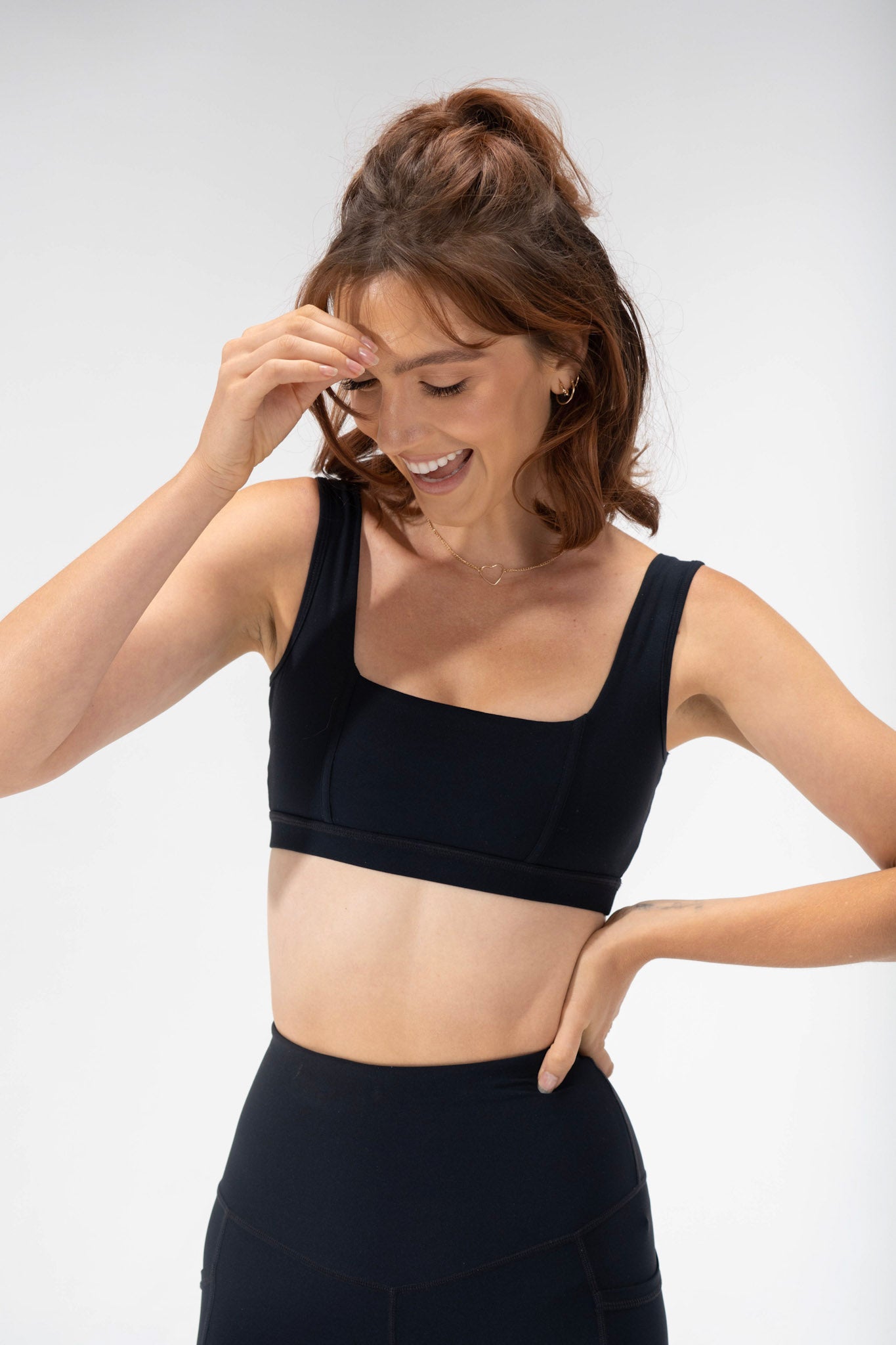 front view of the criss cross sports bra from the POPFLEX basics collection, cute activewear corset bra in black