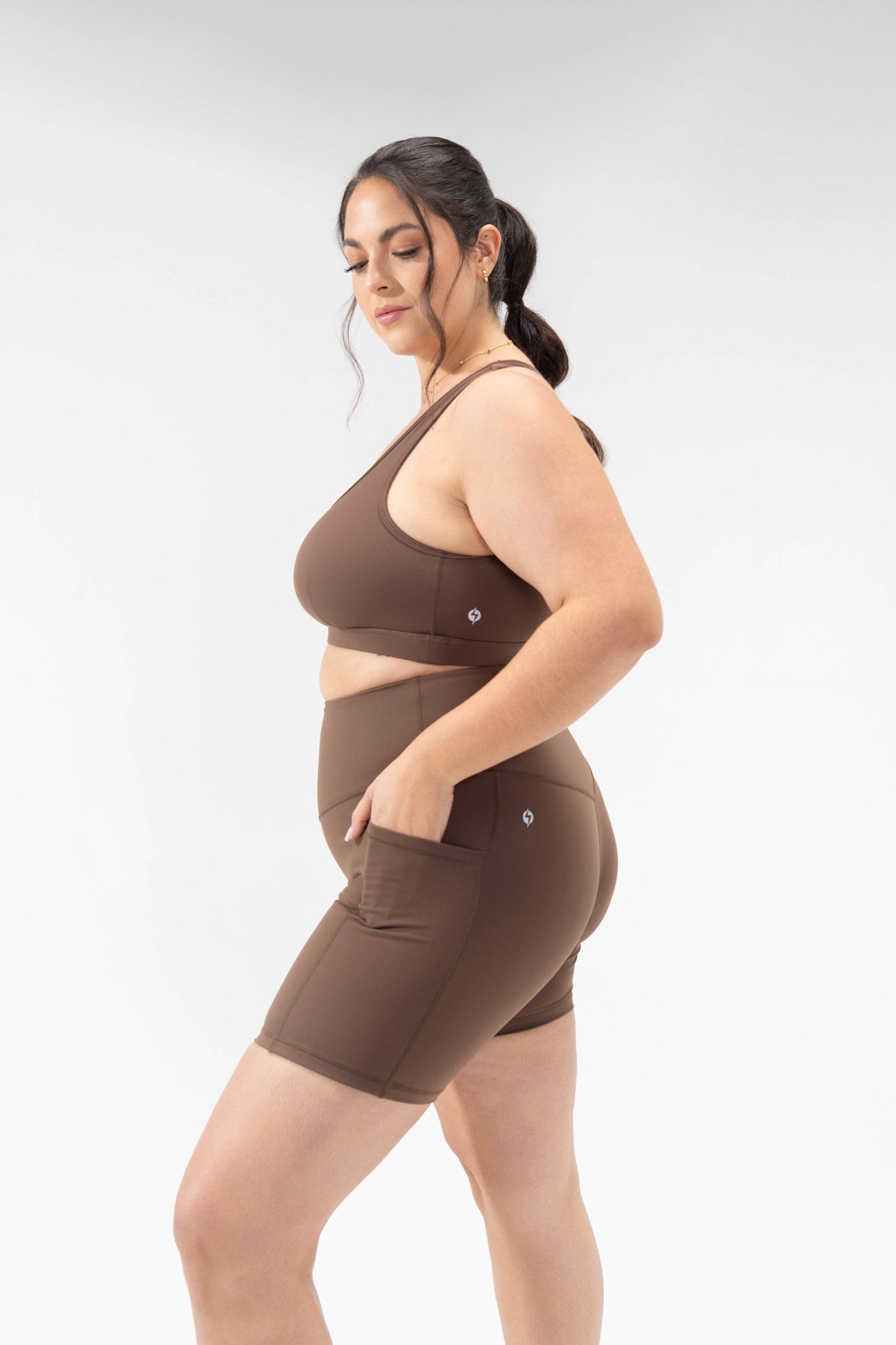 plus size model wears mocha cute activewear set, biker shorts and sports bra from POPFLEX basics collection, captivate bra supersculpt short