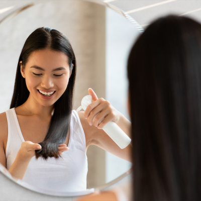 woman examining hair