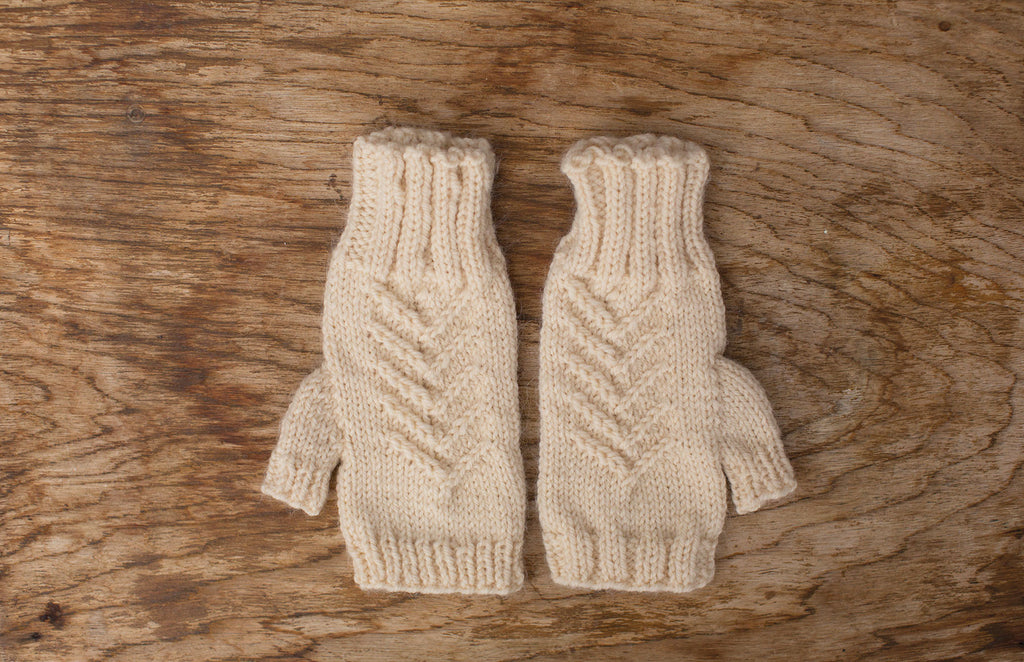 White fingerless gloves. Handmade by the TOM BIHN Ravelry group for the TOM BIHN crew.
