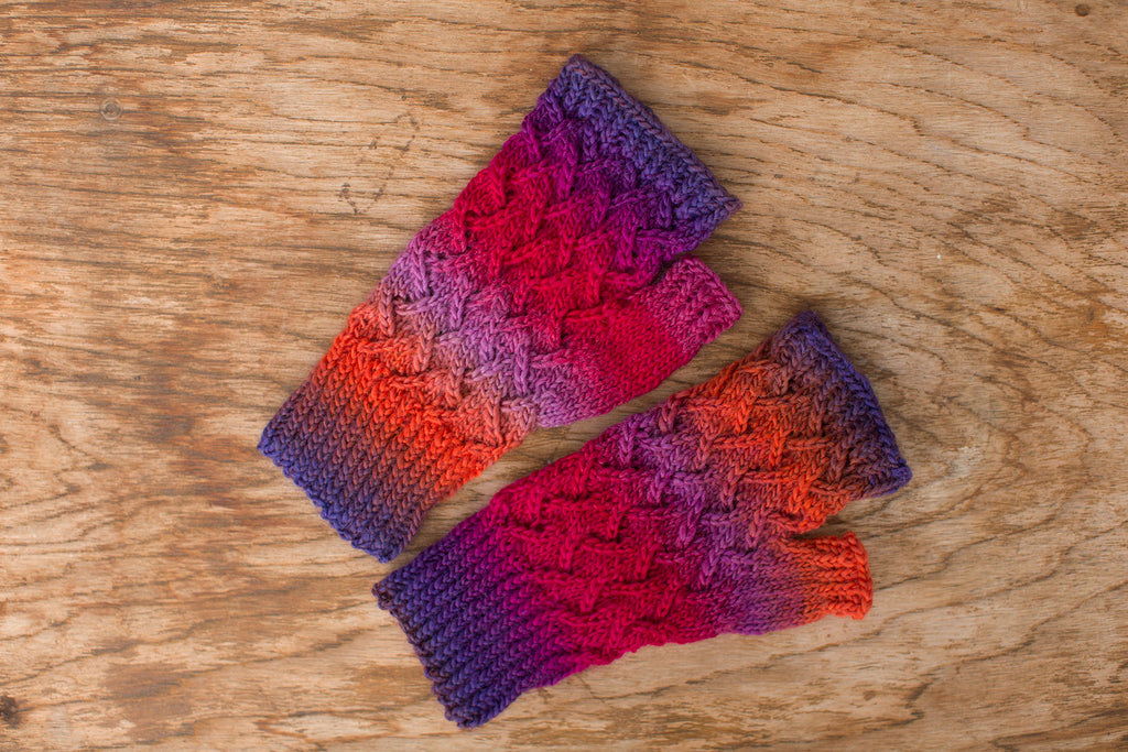 Red, orange, purple and blue fingerless mittens. Handmade by the TOM BIHN Ravelry group for the TOM BIHN crew.