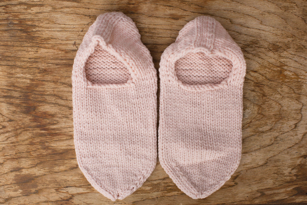 Pale pink slippers. Handmade by the TOM BIHN Ravelry group for the TOM BIHN crew.