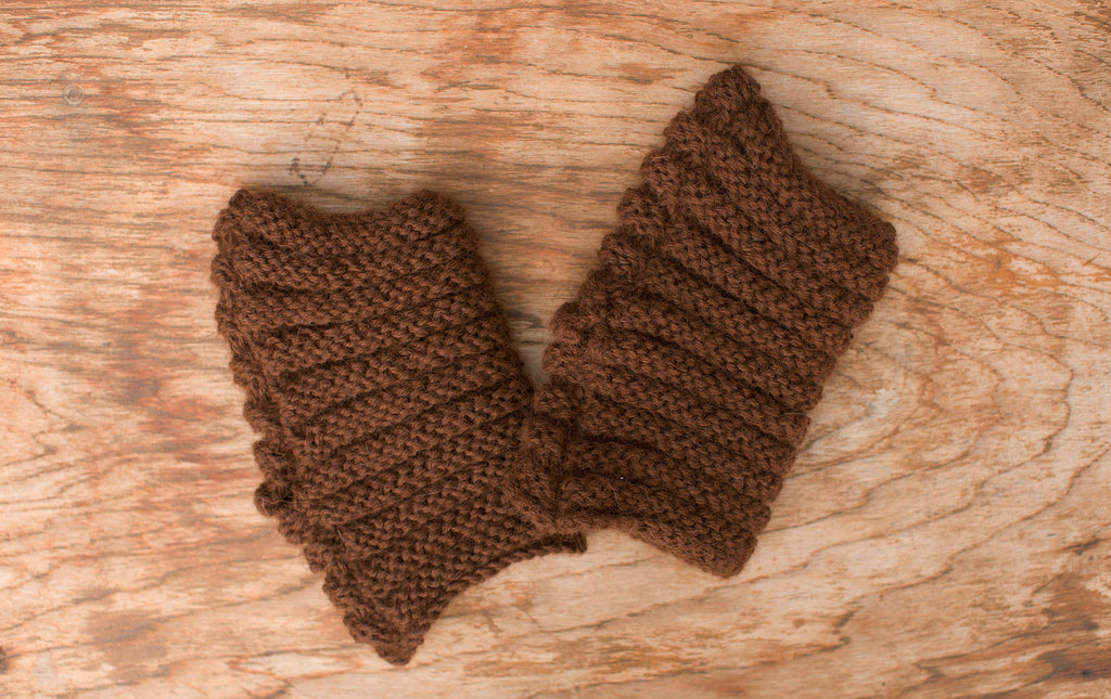 Rich brown fingerless mittens/wrist warmers. Handmade by the TOM BIHN Ravelry group for the TOM BIHN crew.