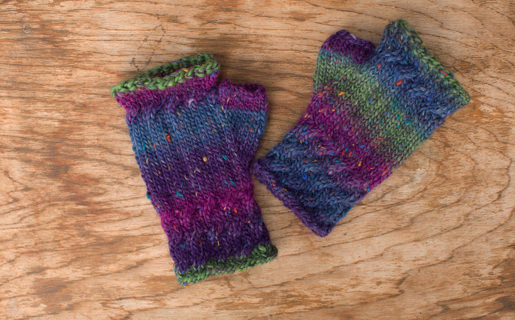 Green, purple, and blue fingerless gloves. Handmade by the TOM BIHN Ravelry group for the TOM BIHN crew.