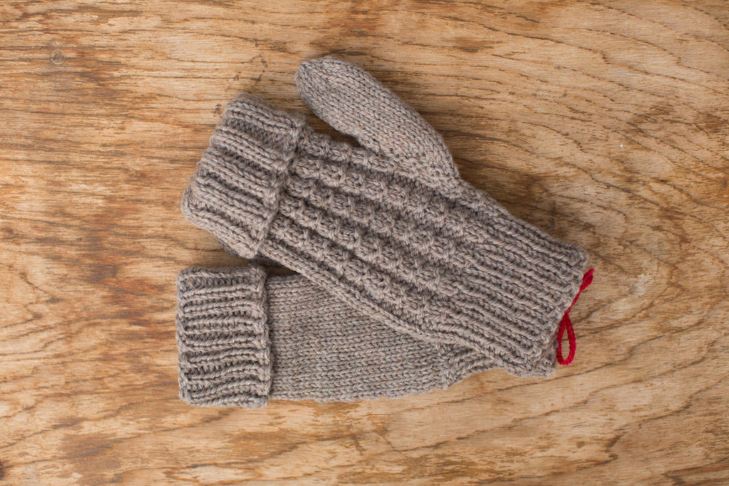 Natural tan fingerless gloves. Handmade by the TOM BIHN Ravelry group for the TOM BIHN crew.