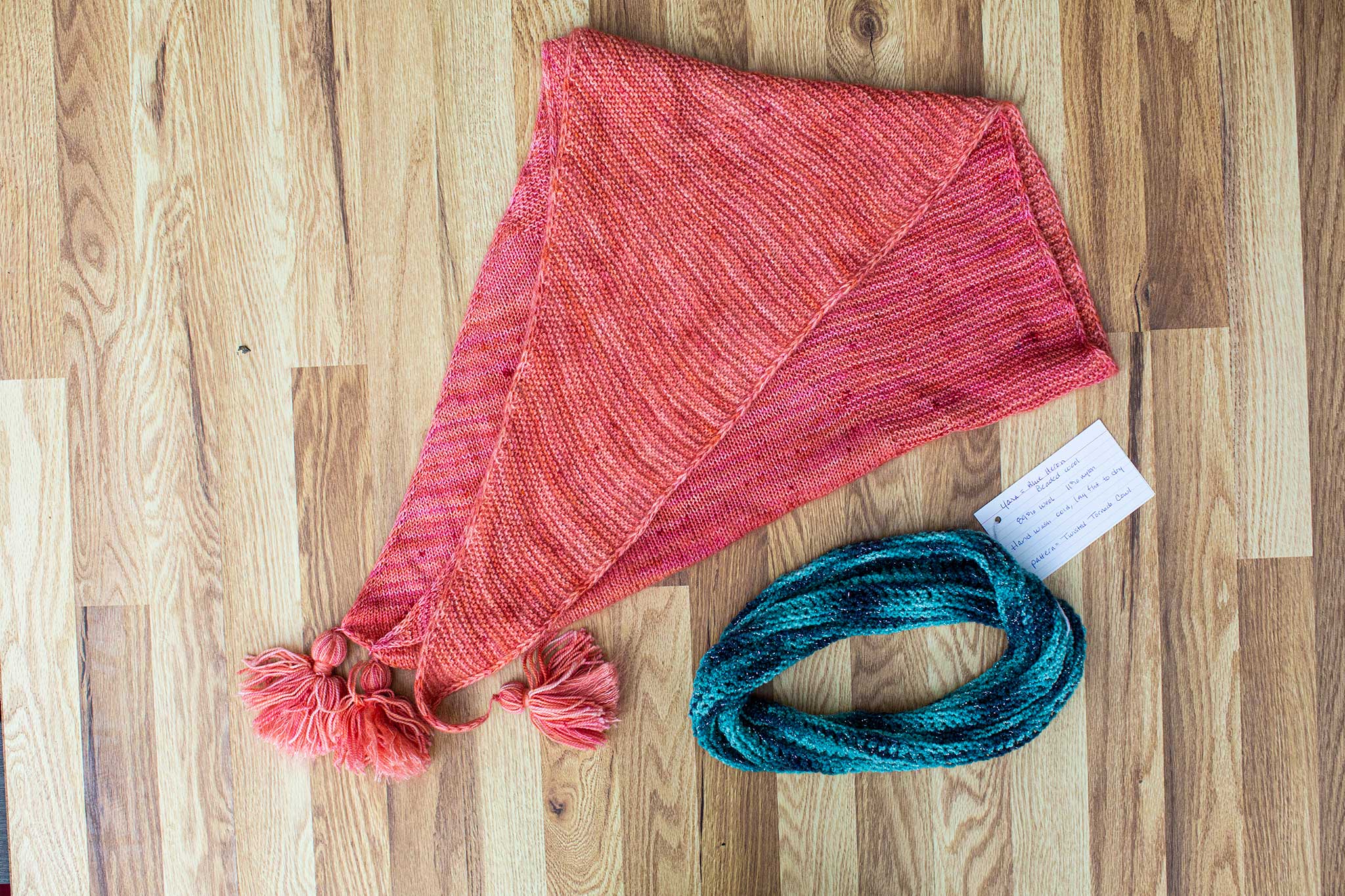 A peach/pink shawl, alongside a blue/green cowl.