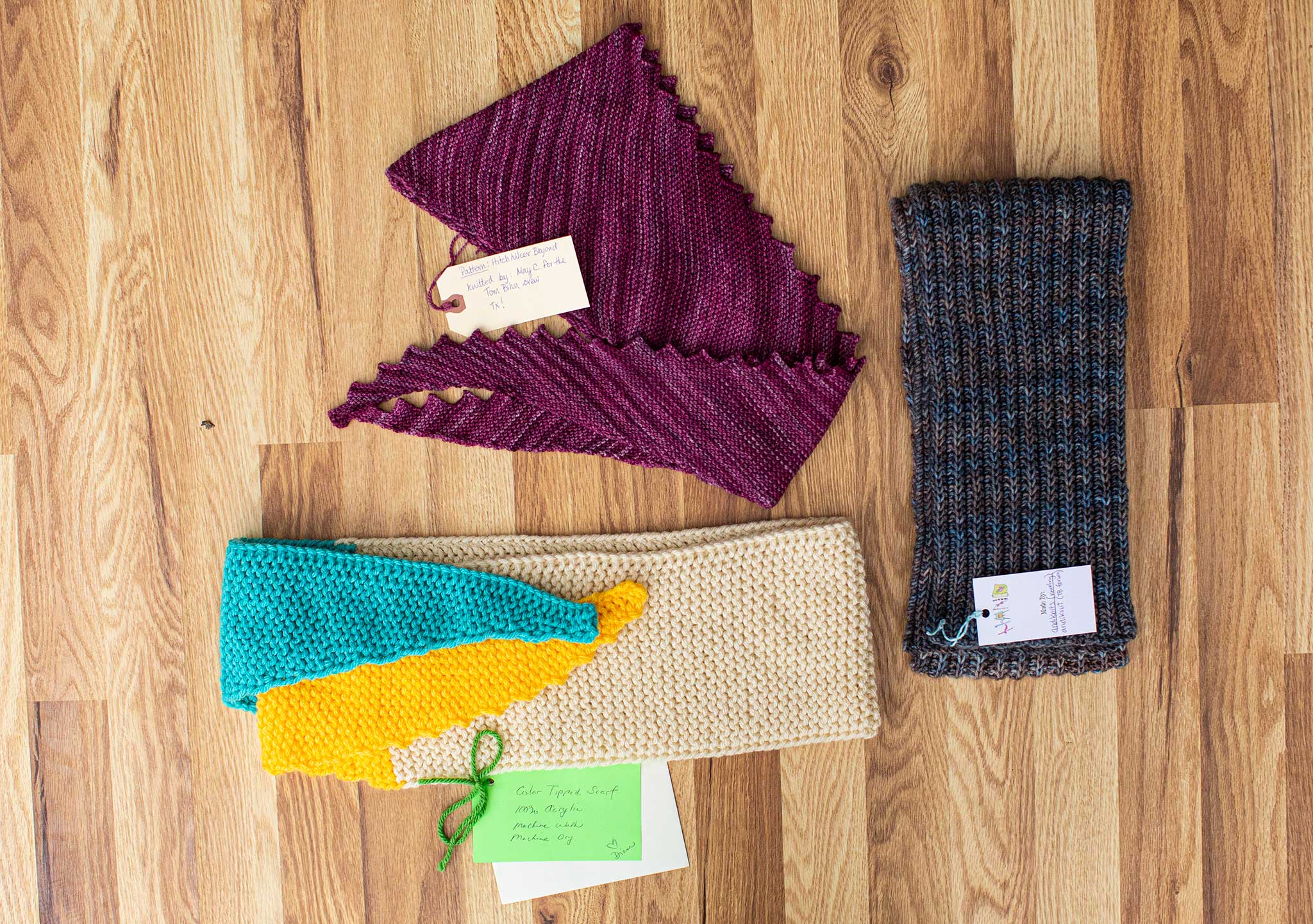 Three beautiful cowls and scarves! One is purple/red, blue/green, and white/blue/yellow.
