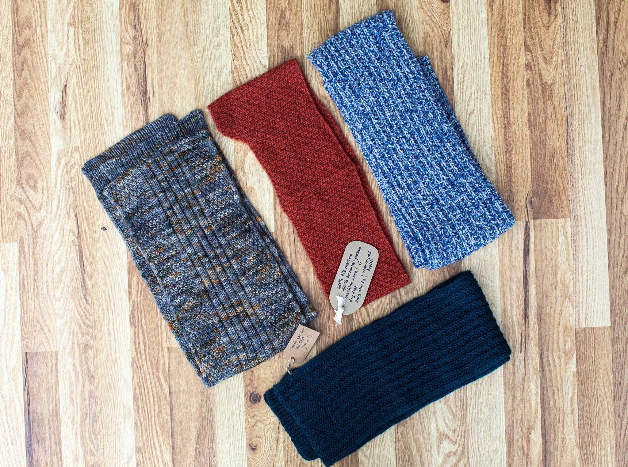 Four beautiful crafted items in blue, dark green, shades of grey and rust red.
