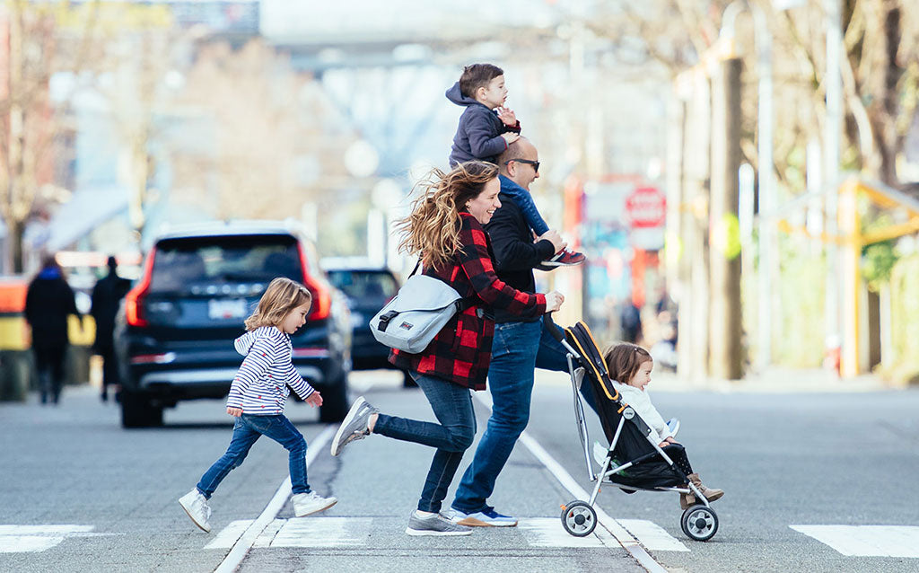 Family crossing the street; mom is wearing a Medium Cafe Bag in Cloud 525d.