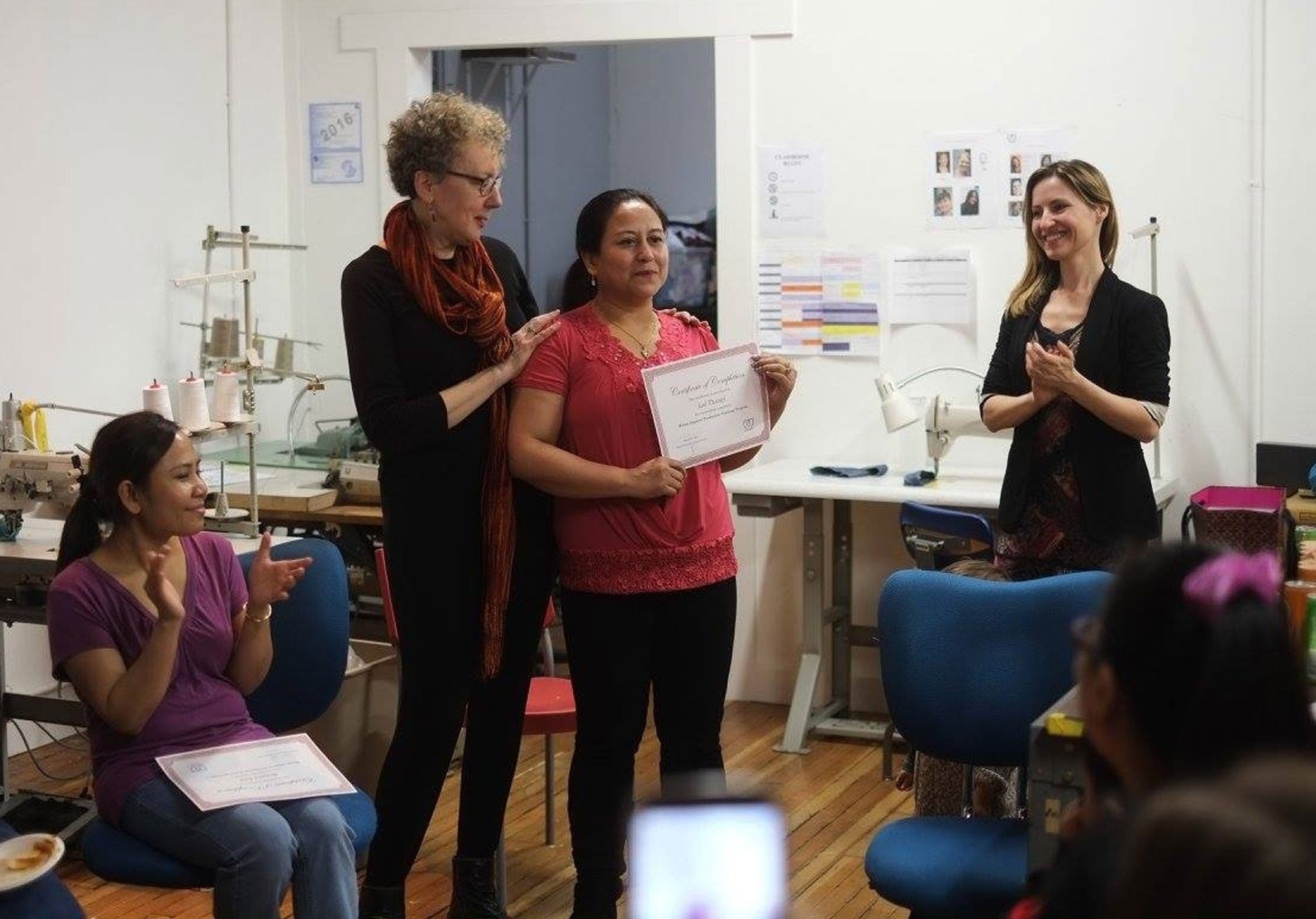 Person getting a certificate from Seattle Muses