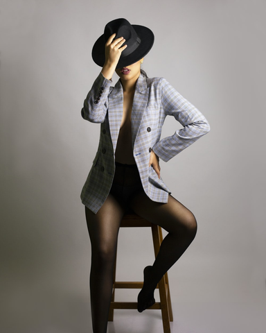 : A woman in a coat and hat from an online consignment store