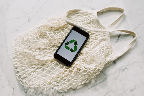 An eco-friendly bag with a phone with a logo on it