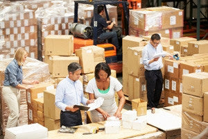 Employees packaging boxes to ship from warehouse