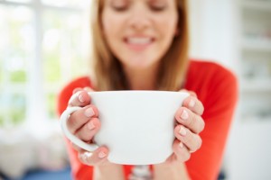 Woman Using Glass to avoid Toxins