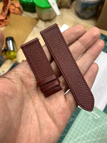 20mm Burgundy Epsom Leather tapered to 18mm at buckle.