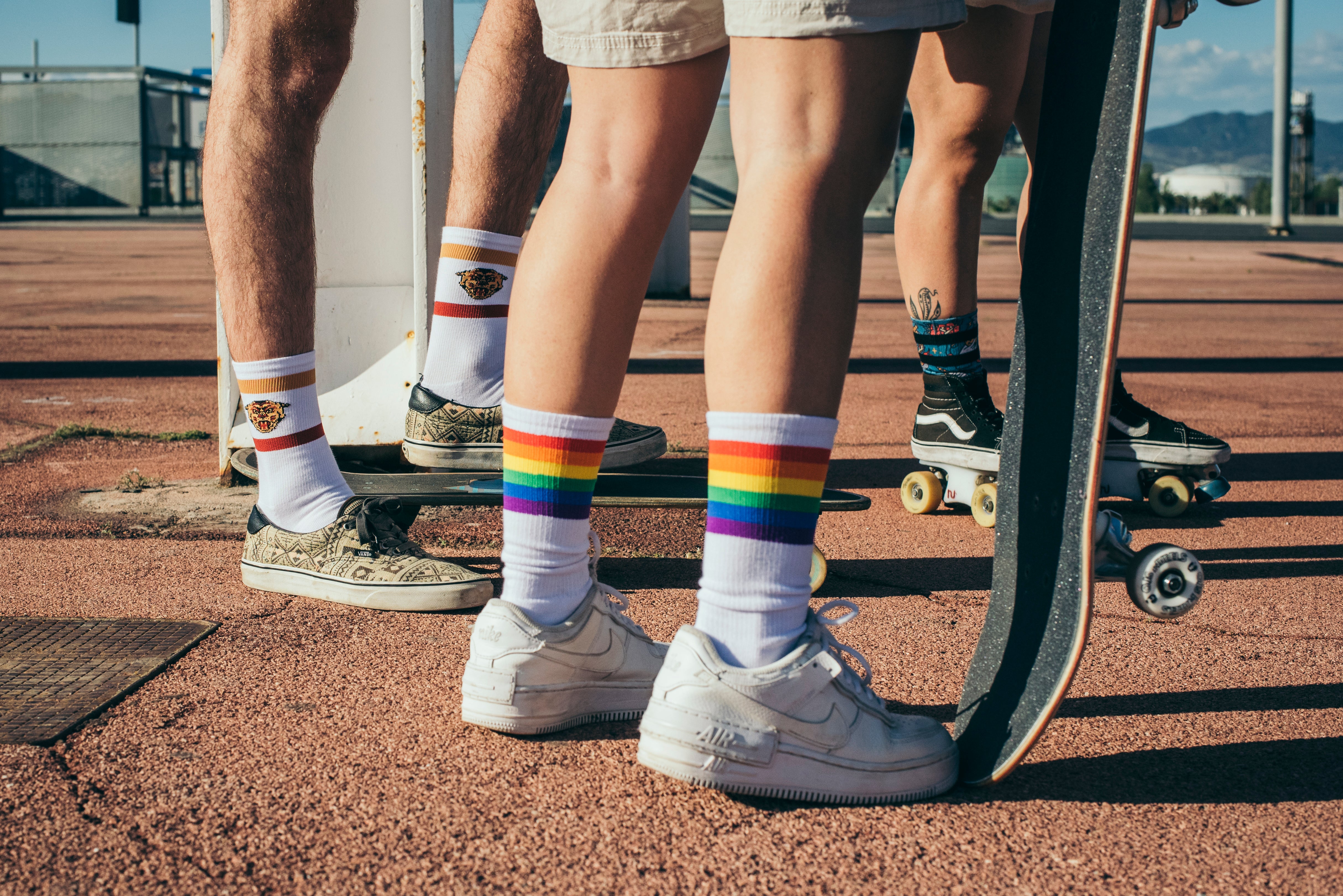 three people from the waist down with skates and wearing American Socks 