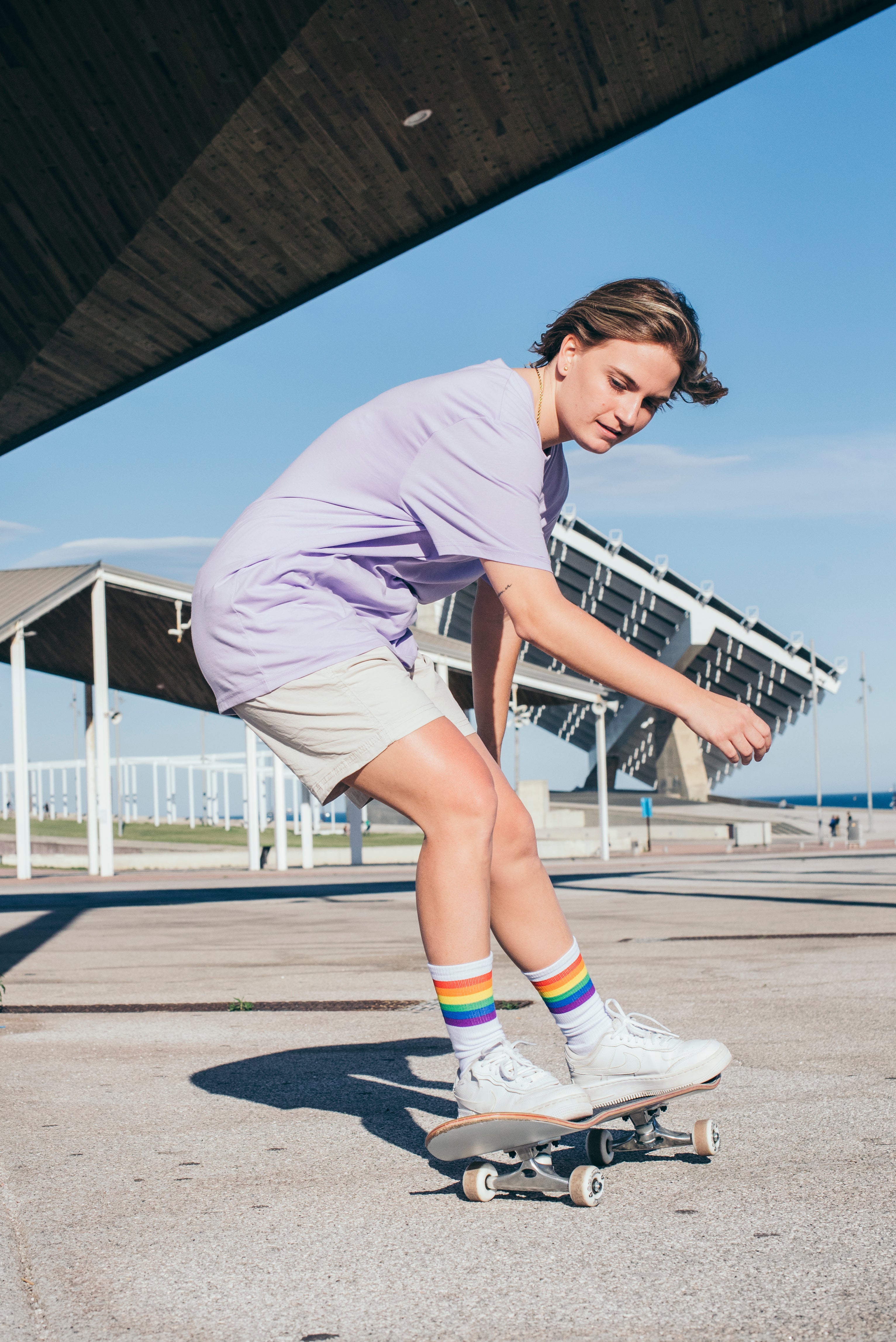 Person with Rainbow Pride Socks skateboarding