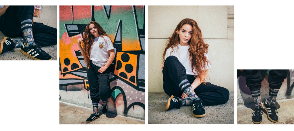 three images of a model wearing the conspiracy socks against a grafiti wall 