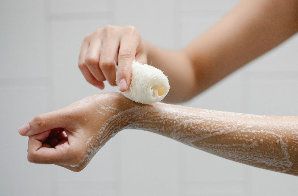 a woman using body wash for dry skin