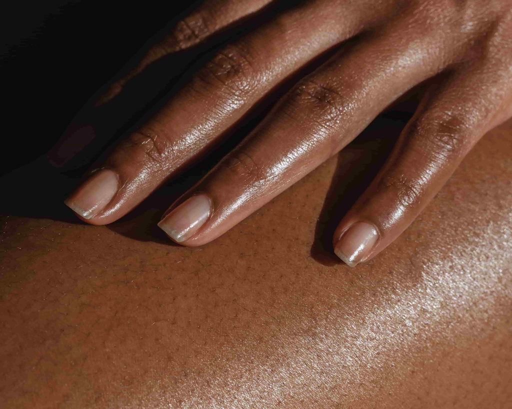Close-up of woman touching skin