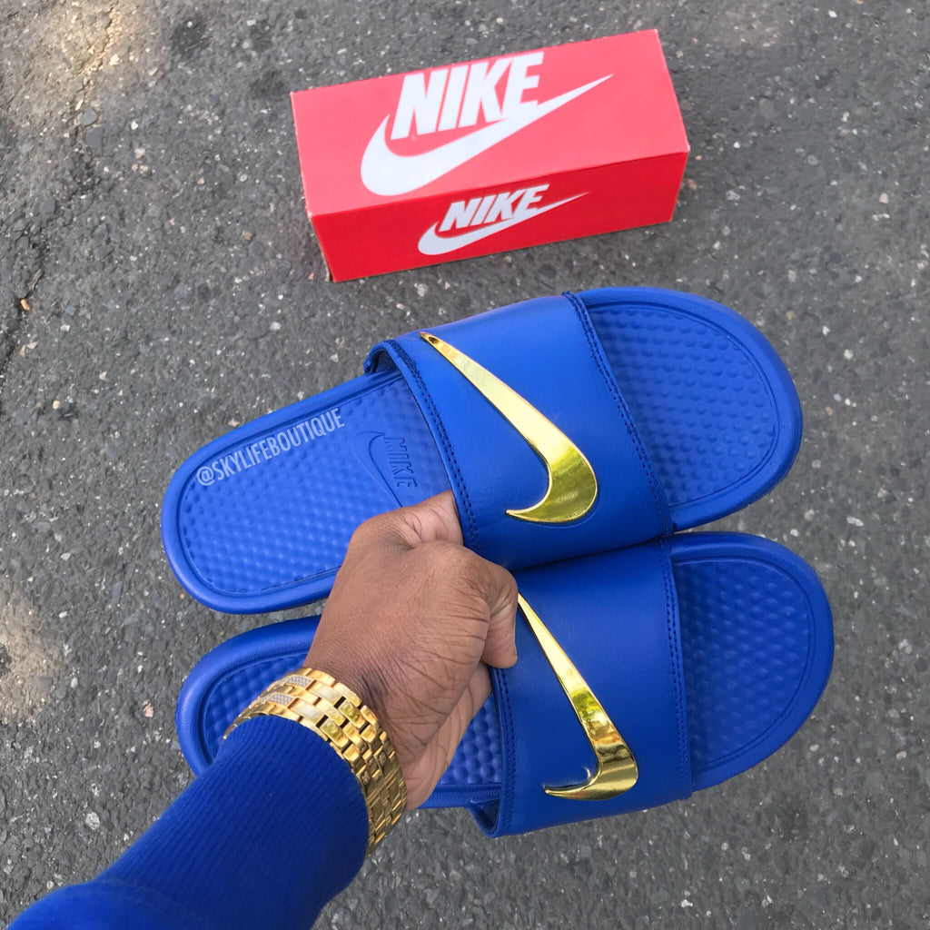 red nike slides with gold check