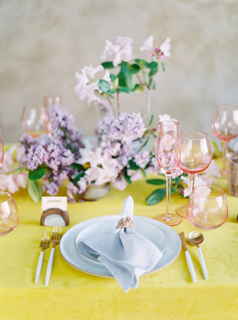 Wedding pop of color, delicate place setting with lavender florals and macramé