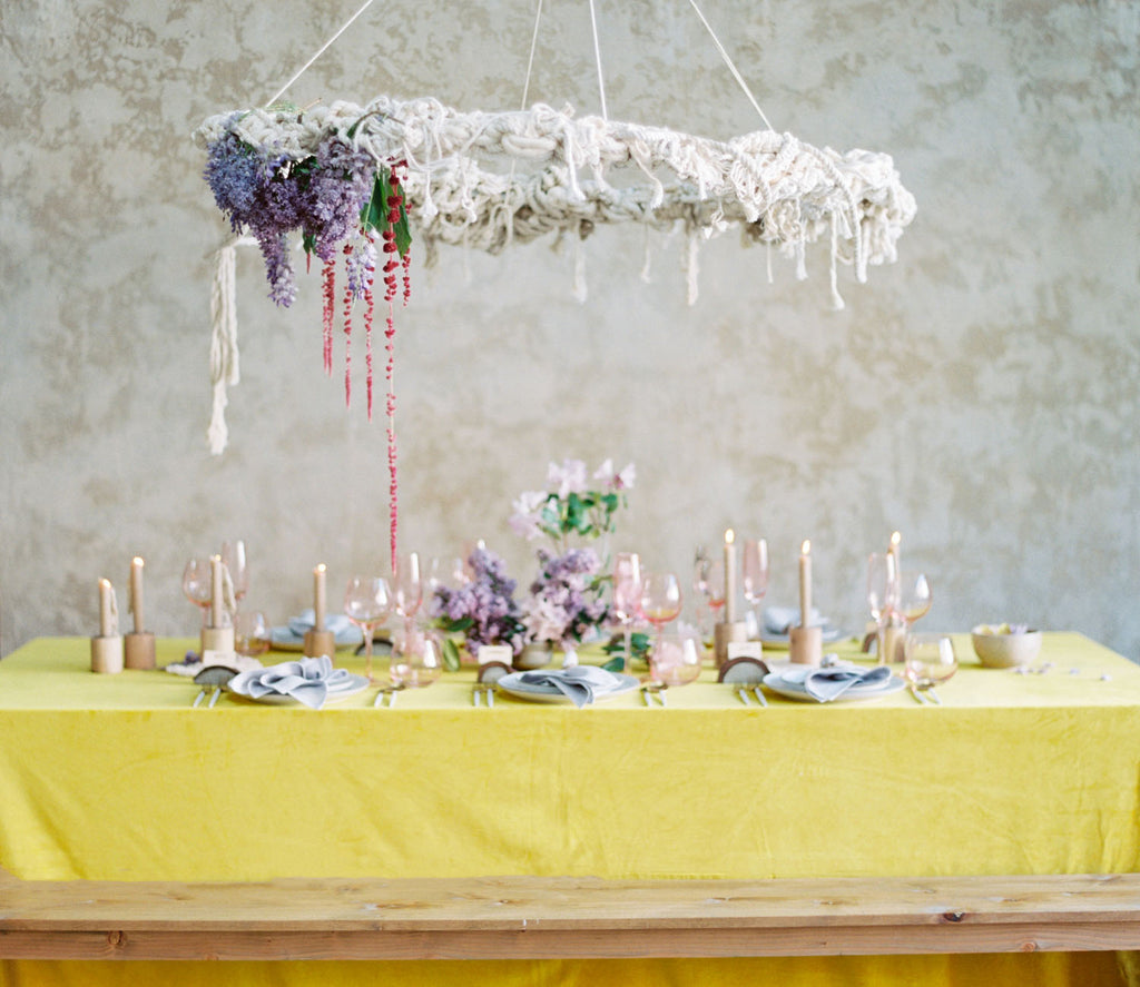 Whimsical macramé wedding table setting with a pop of color