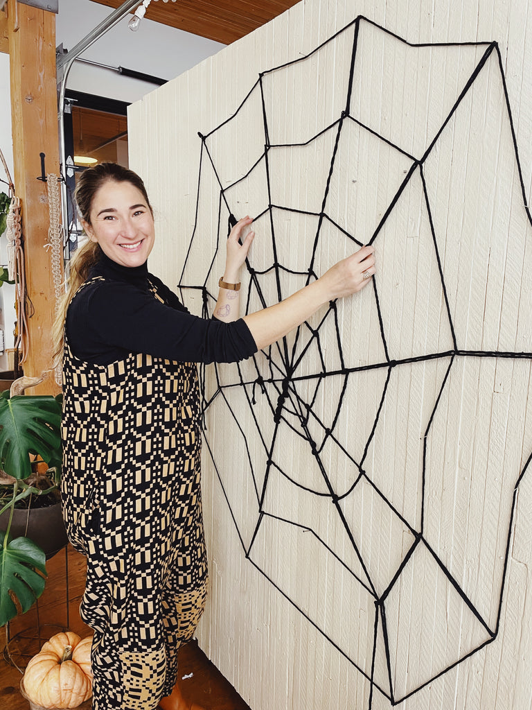 Emily Katz with a spooky string spiderweb