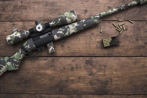 rifle on wooden table