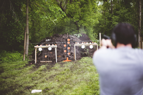 man aiming at shooting targets at an outdoor shooting range