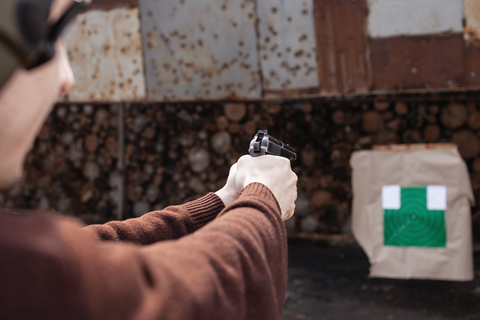 woman using gun to aim at target