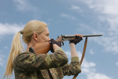 woman aiming with rifle