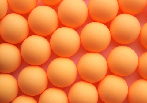 multiple ping pong balls arranged next to each other