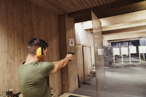 man aiming at a target at range