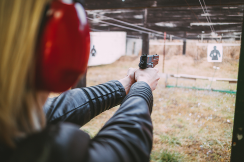 women with hearing aids aiming at shooting targets