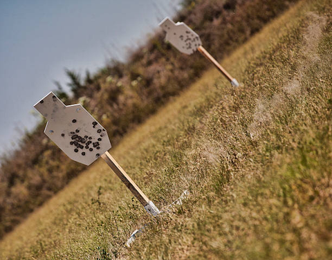 white shooting target with bullet marks