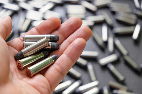 man holding bullets in hand