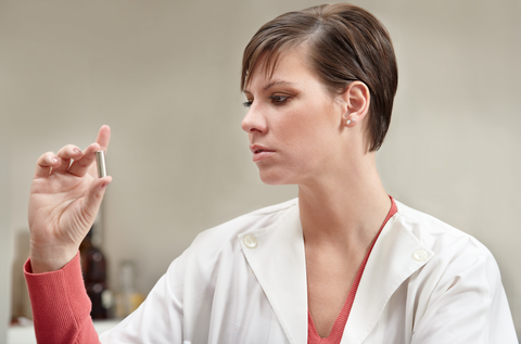 woman inspecting bullet