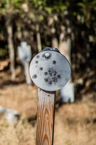 steel metal plate with bullet marks